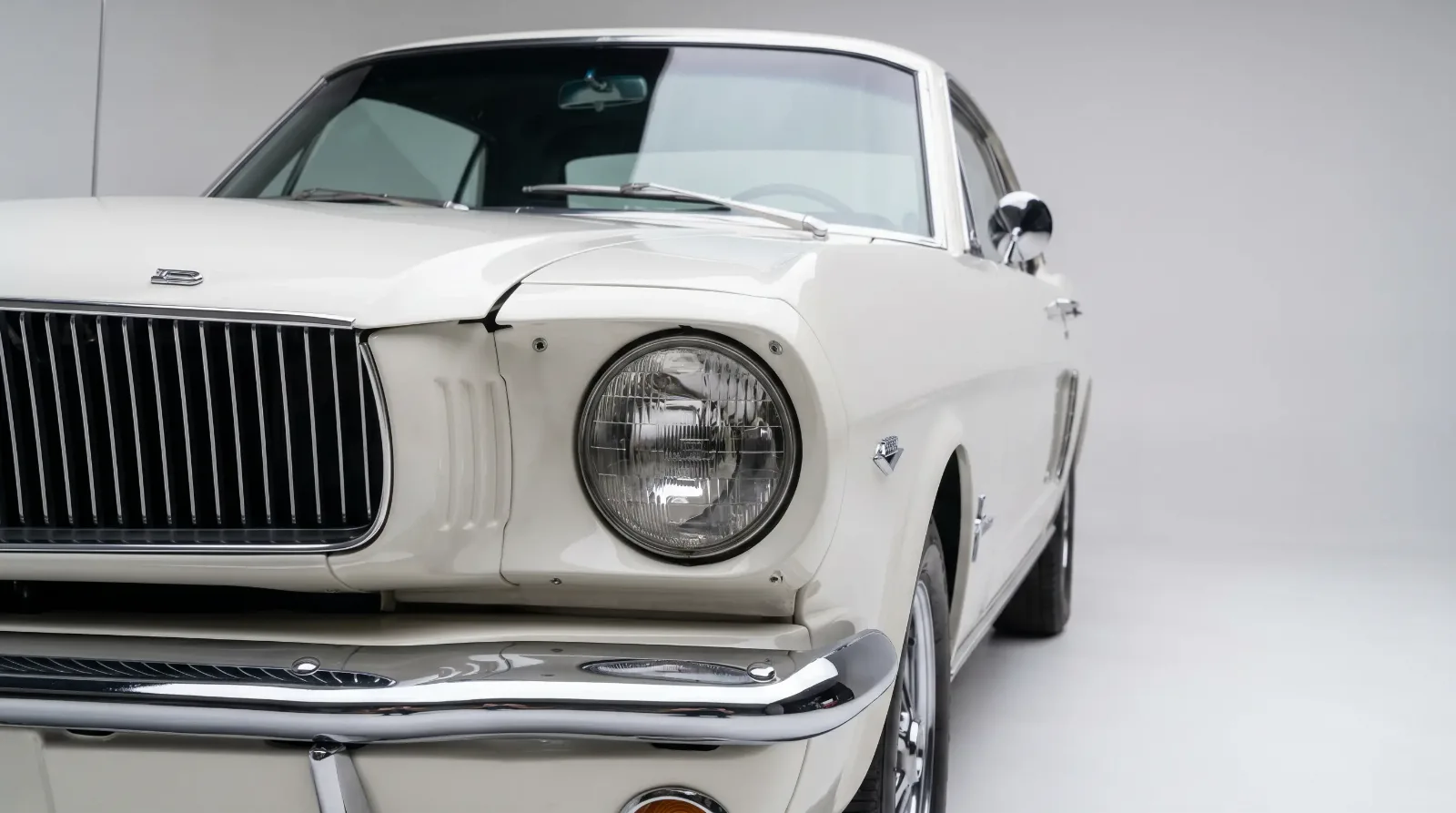 Clean detail of a classic 1965 Ford Mustang grille and fender